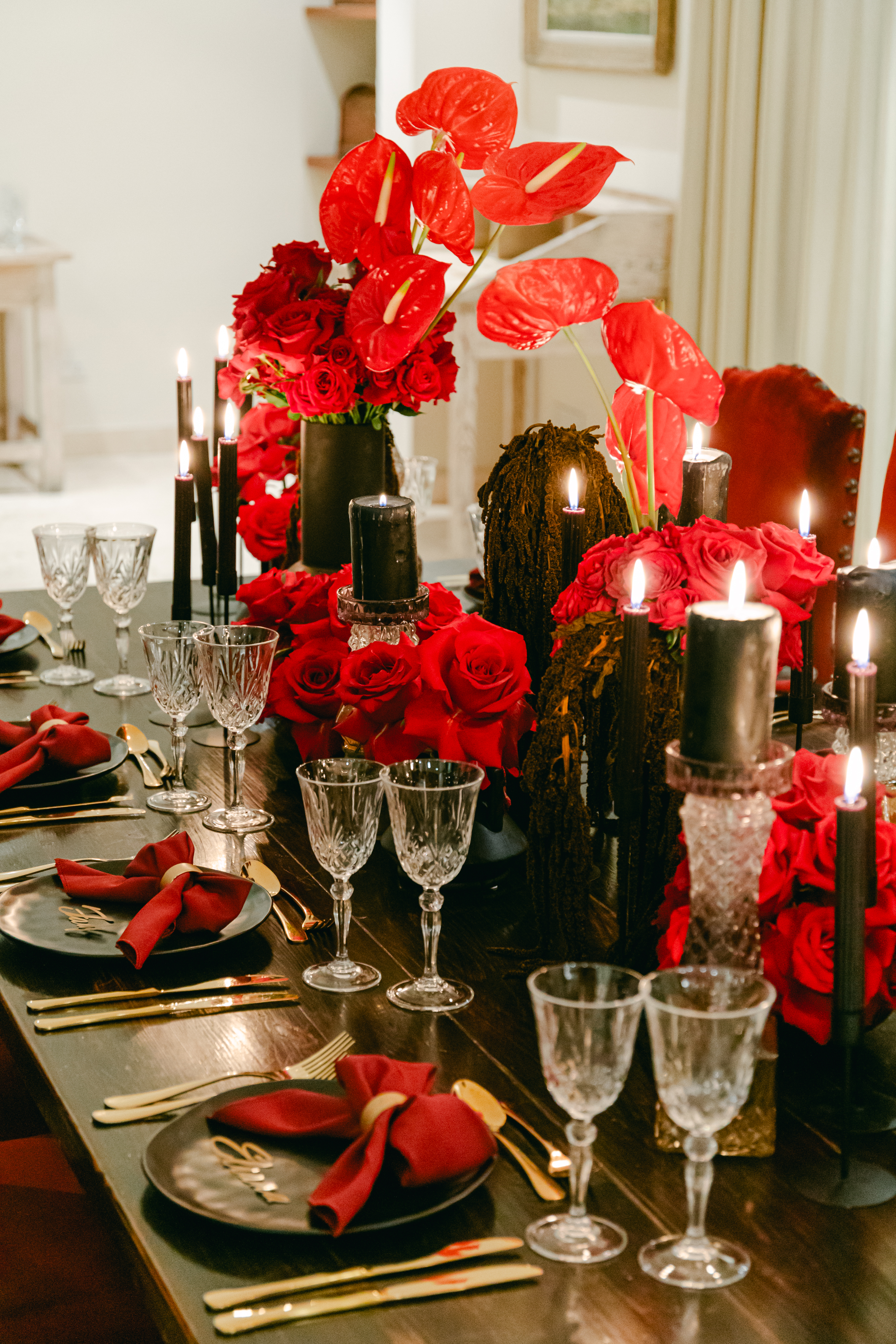 Red and black tablescape with roses and black candles