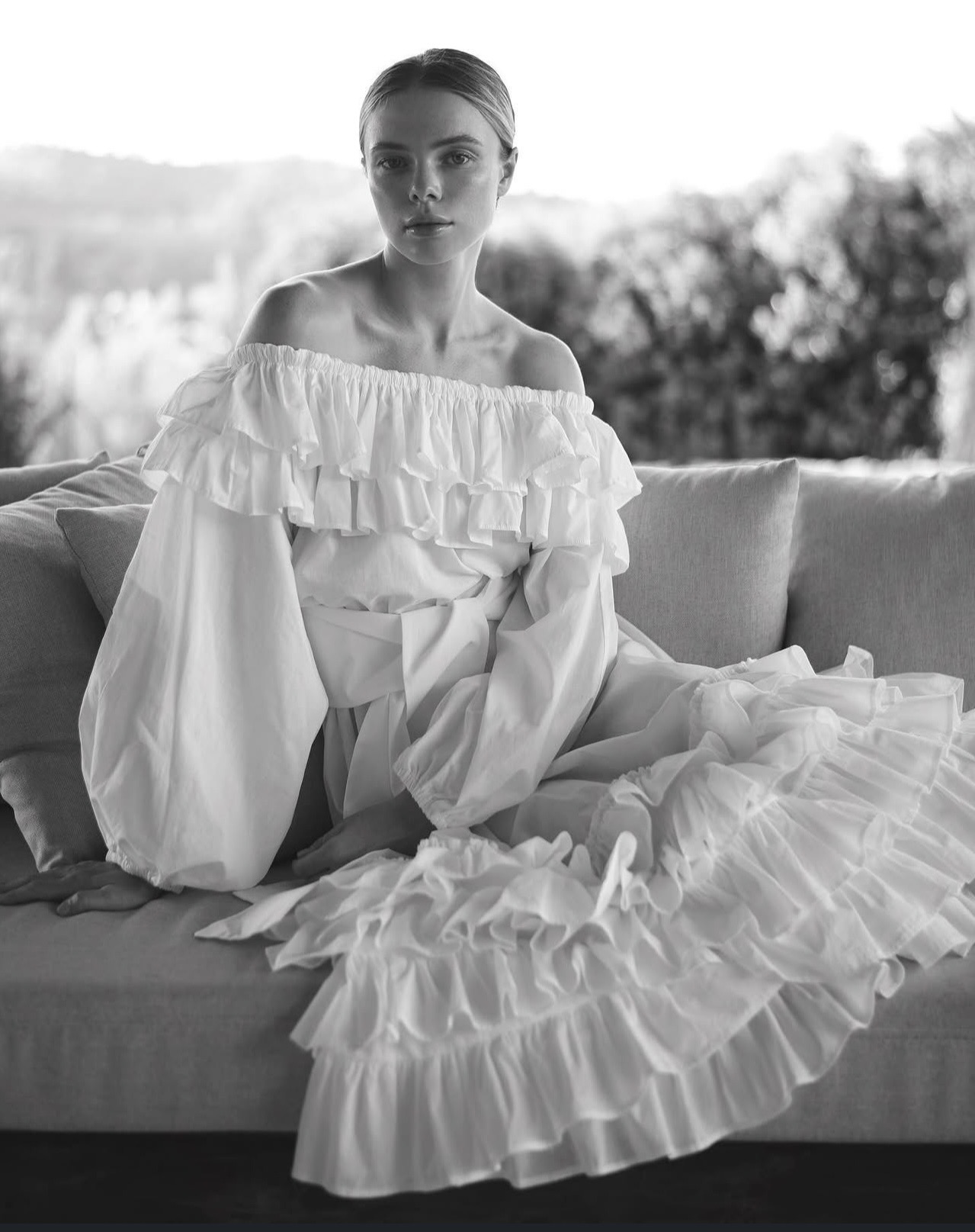 Model in a white off-shoulder ruffled dress